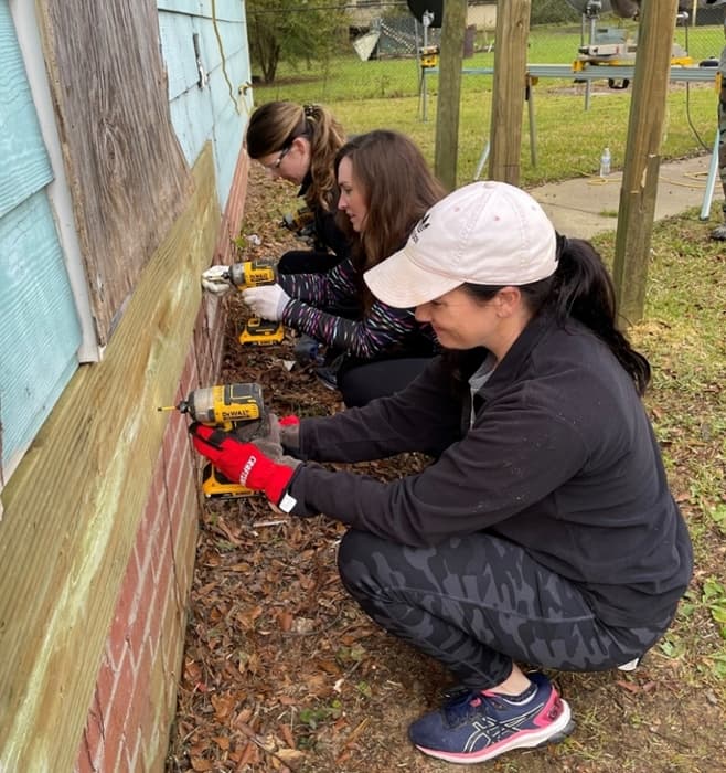 Drs. Erin Dehon, Victoria Ross, and Lauren Zvolanek at Habitat for Humanity build